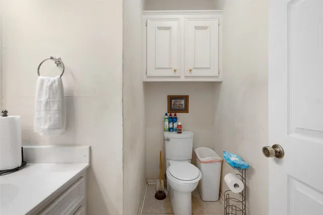 a white toilet sitting next to a bathroom sink