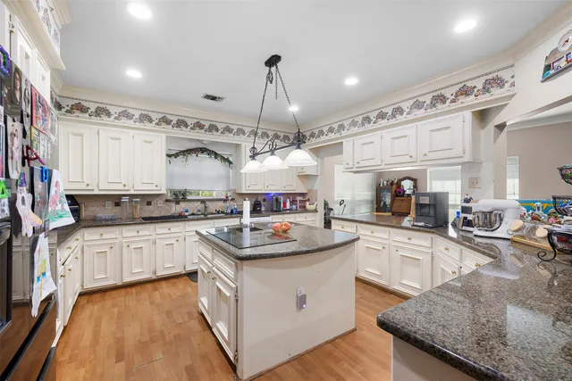 a kitchen with a sink stove and cabinets