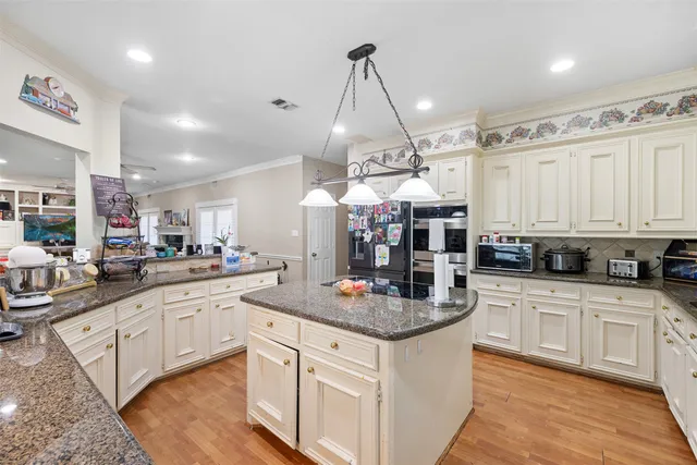 a kitchen with stainless steel appliances granite countertop a sink and cabinets