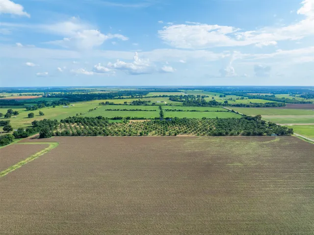 an aerial view of a house with a lake