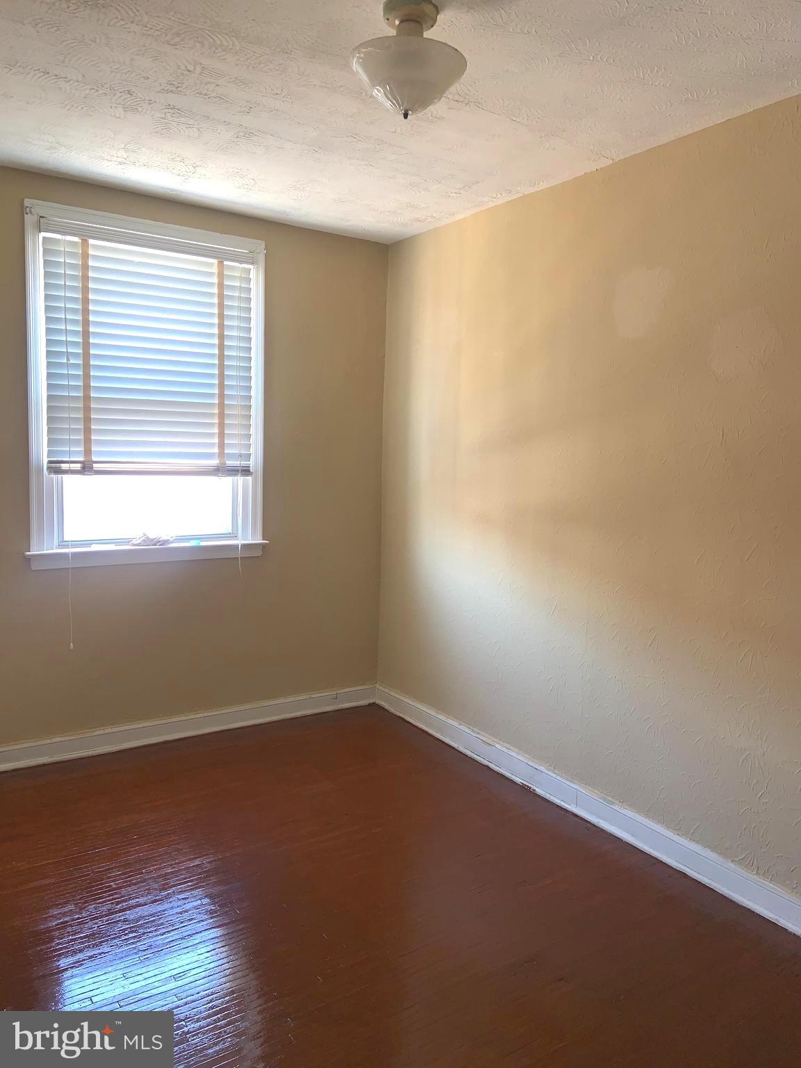 4613 Hartel Avenue Philadelphia, PA 19136 - Photo 11 of 17 an empty room with wooden floor and windows