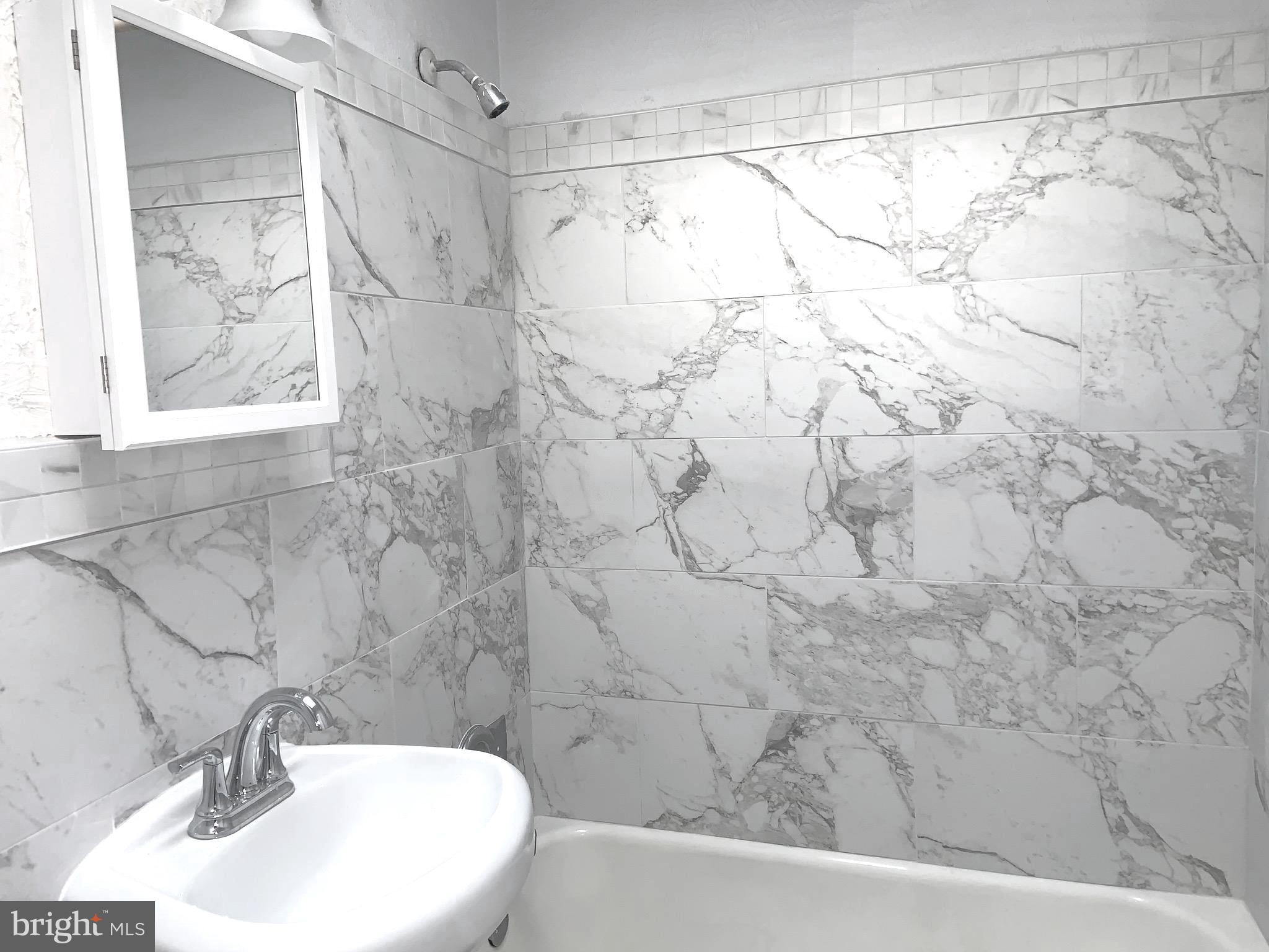 4613 Hartel Avenue Philadelphia, PA 19136 - Photo 6 of 17 a bathroom with a sink and a mirror