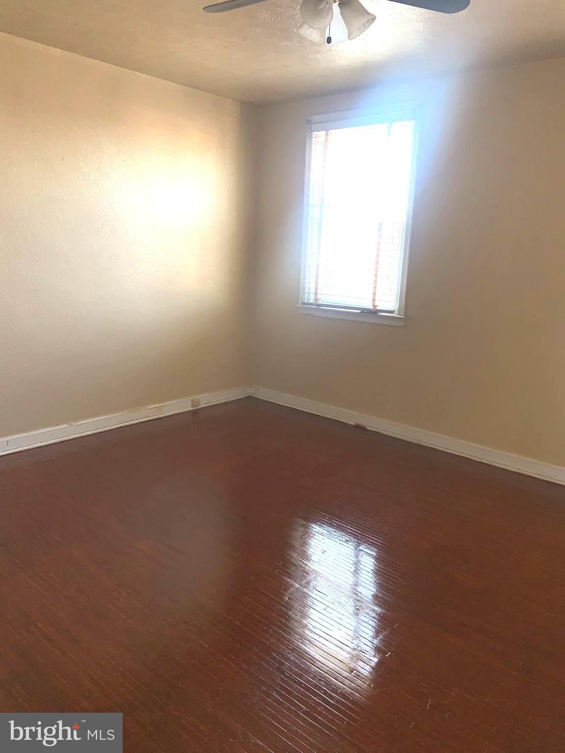 4613 Hartel Avenue Philadelphia, PA 19136 - Photo 7 of 17 an empty room with wooden floor and windows
