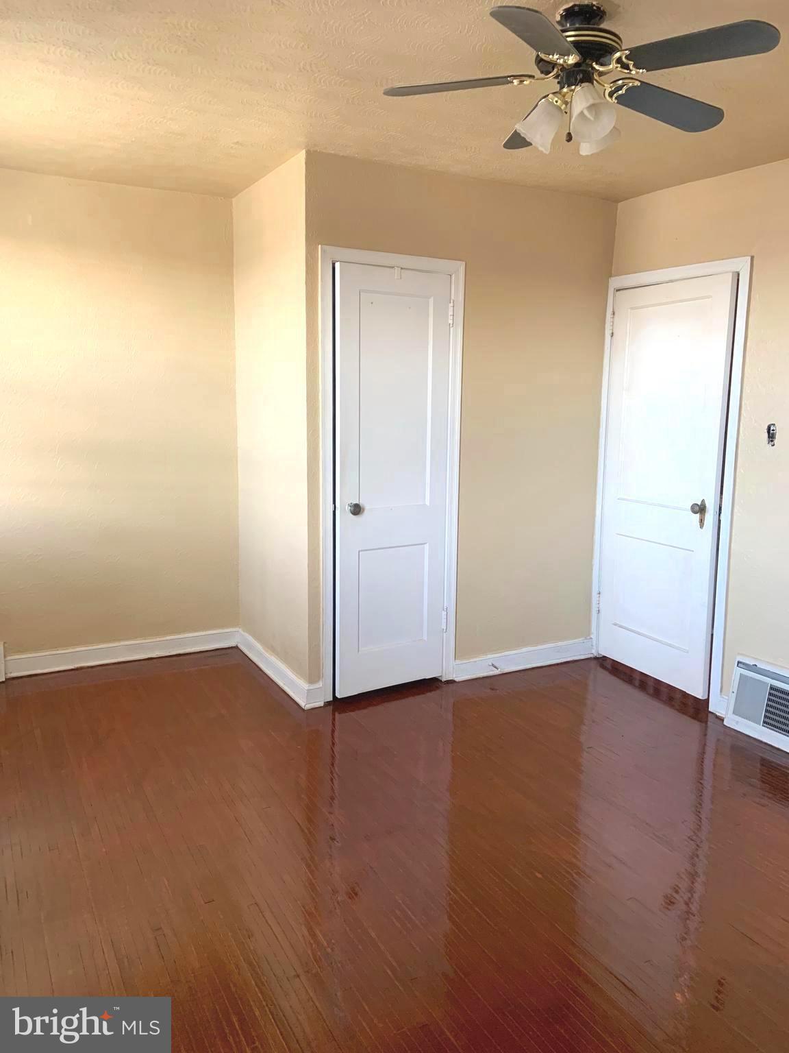 4613 Hartel Avenue Philadelphia, PA 19136 - Photo 9 of 17 an empty room with wooden floor fan and windows