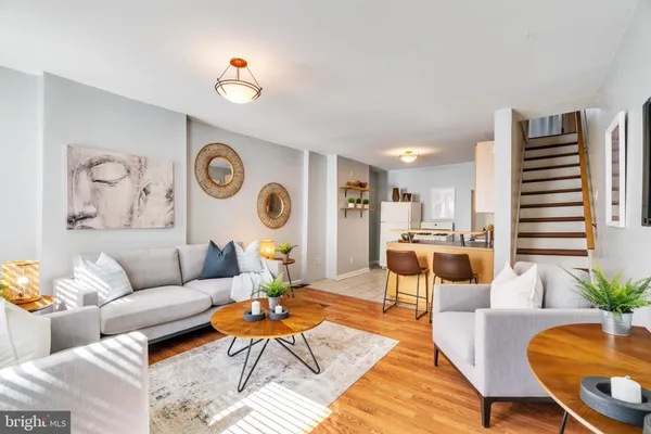 a living room with furniture and wooden floor