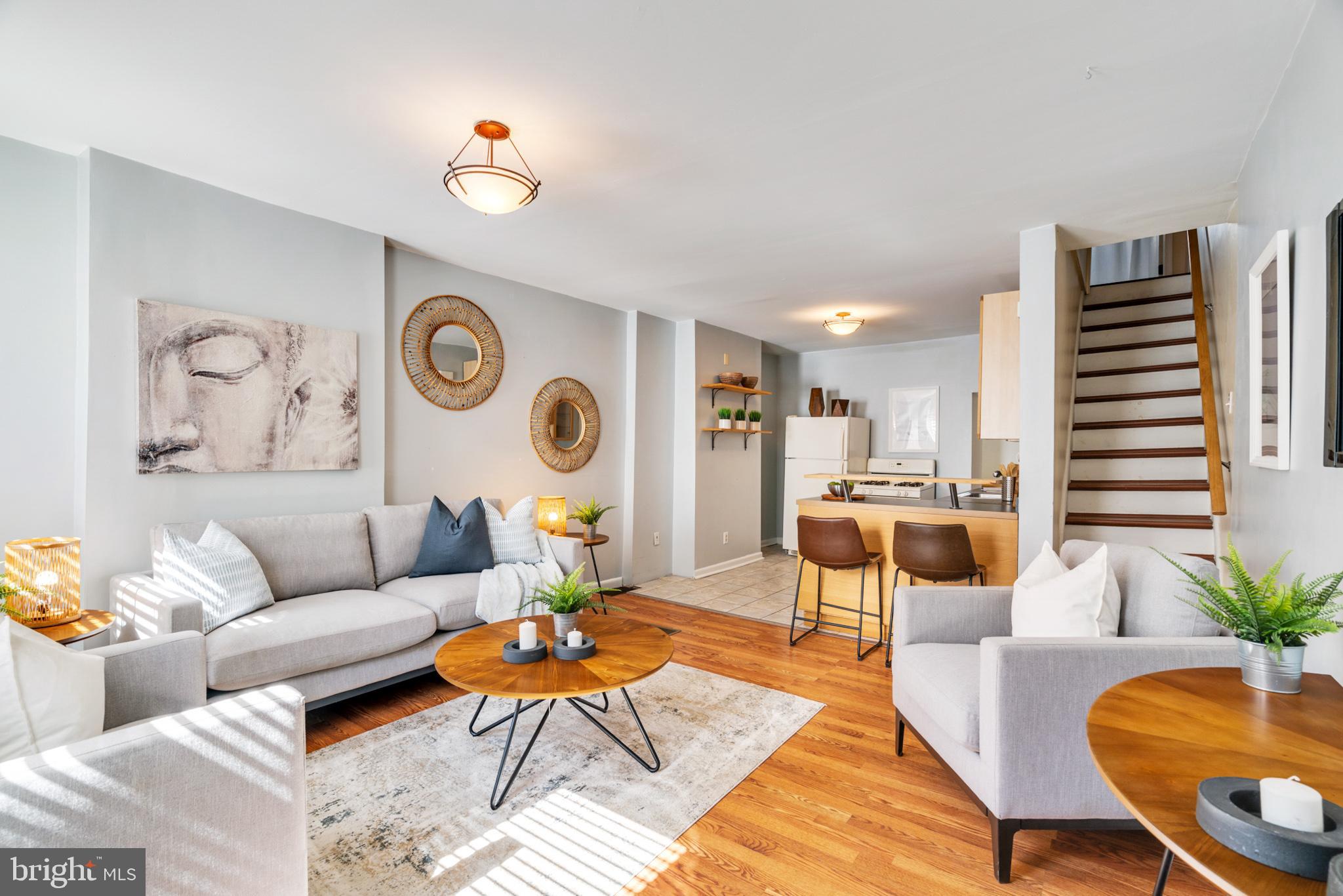 a living room with furniture and wooden floor