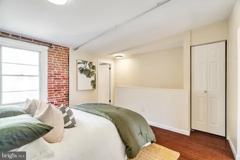 a spacious bedroom with a bed and a window