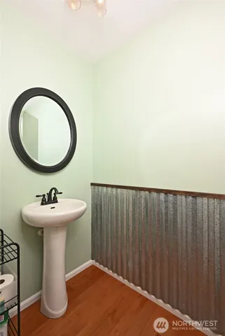 a bathroom with a sink toilet and mirror