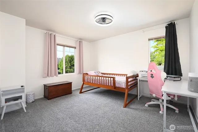 a bedroom with furniture and a window