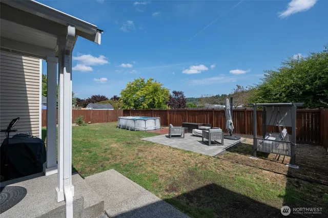 a view of a backyard with sitting area