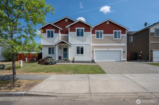 a front view of a house with a yard and garage