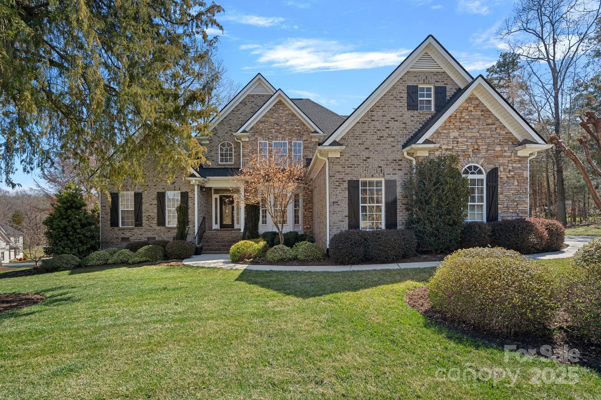 105 Elizabeth Brook Drive Davidson, NC 28036 - Photo 1 of 43 a front view of a house with garden