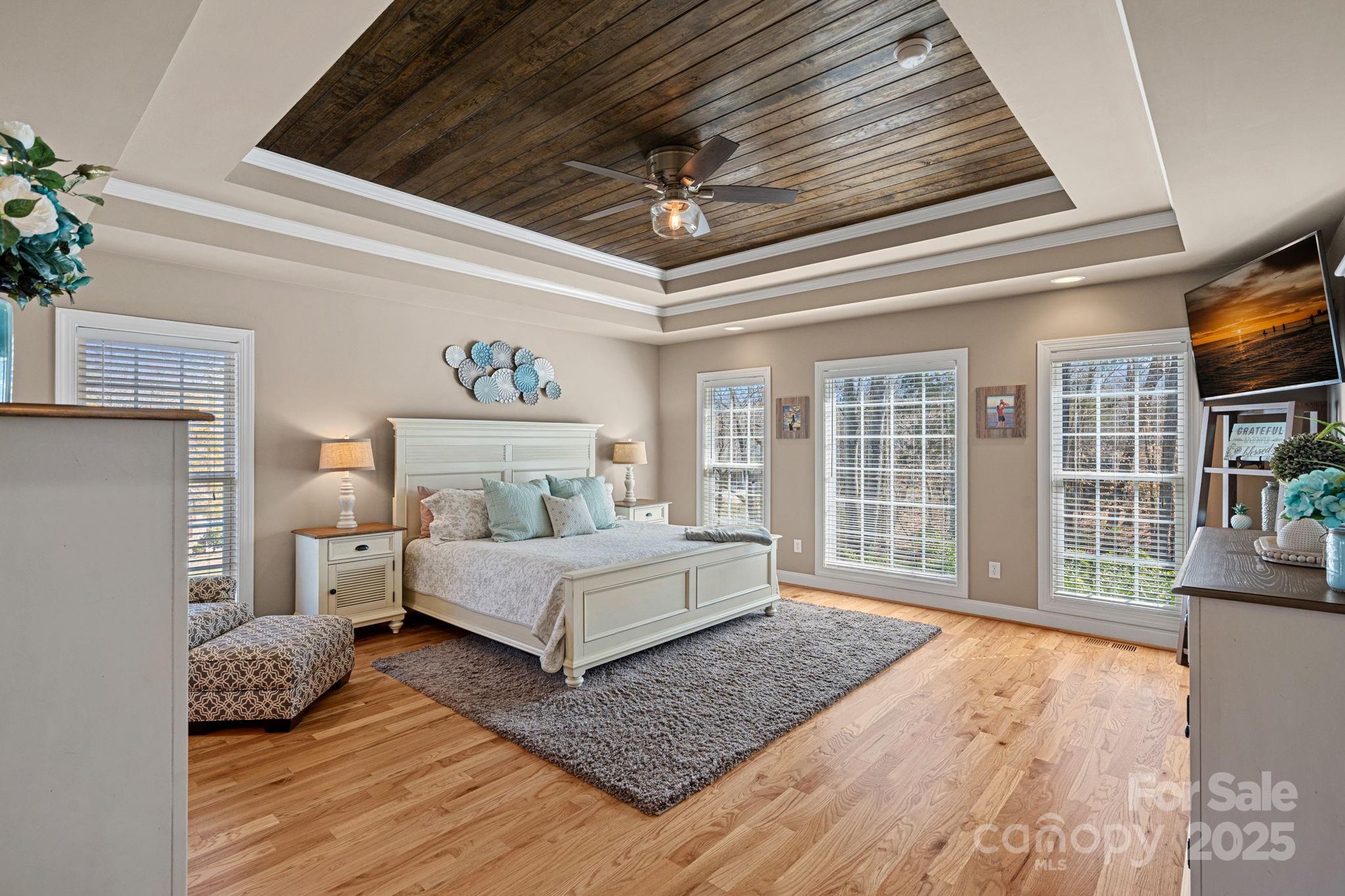105 Elizabeth Brook Drive Davidson, NC 28036 - Photo 12 of 43 a spacious bedroom with a large bed and a chandelier