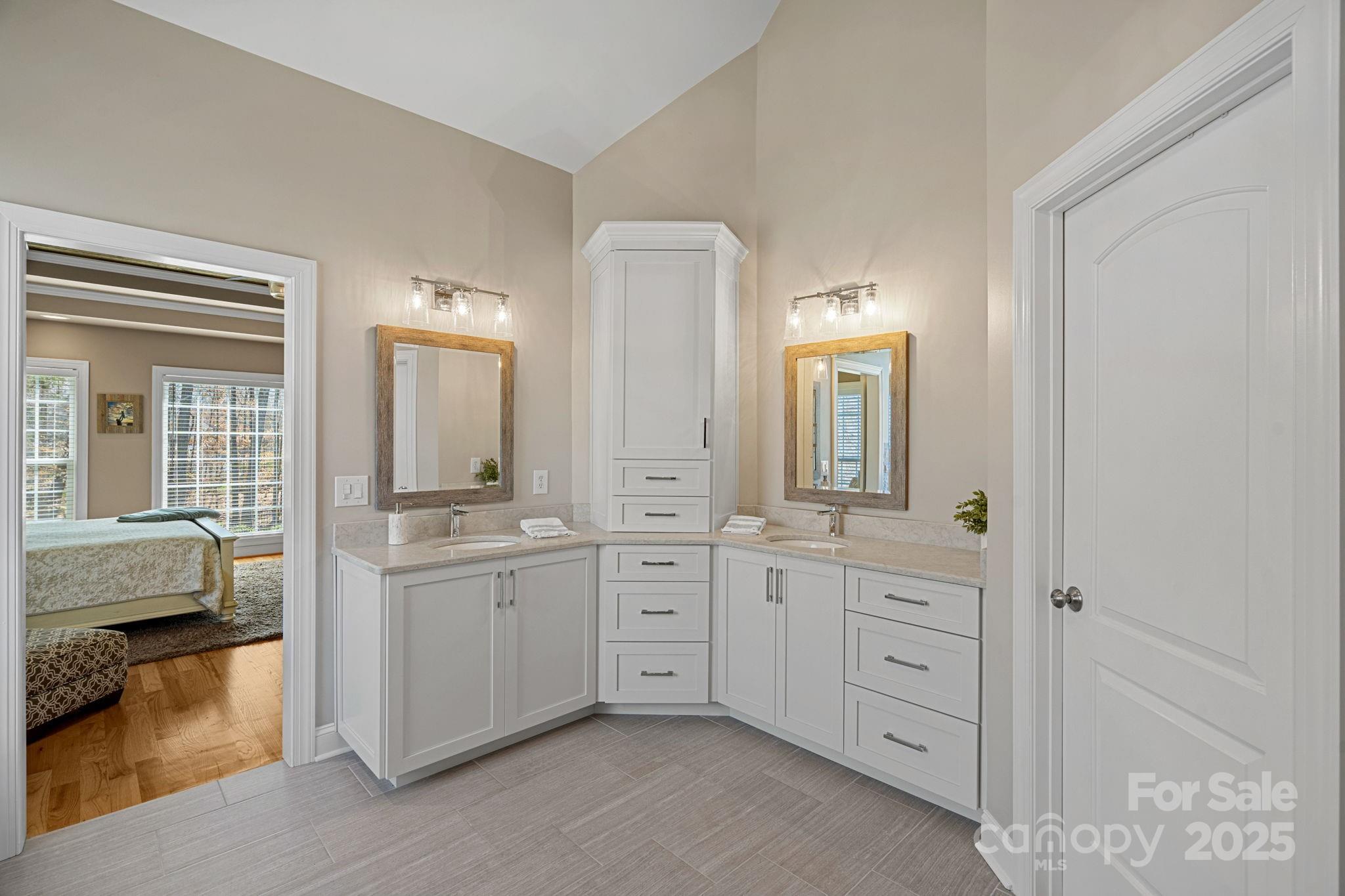 105 Elizabeth Brook Drive Davidson, NC 28036 - Photo 14 of 43 a spacious en suite bathroom with double sink and a mirror