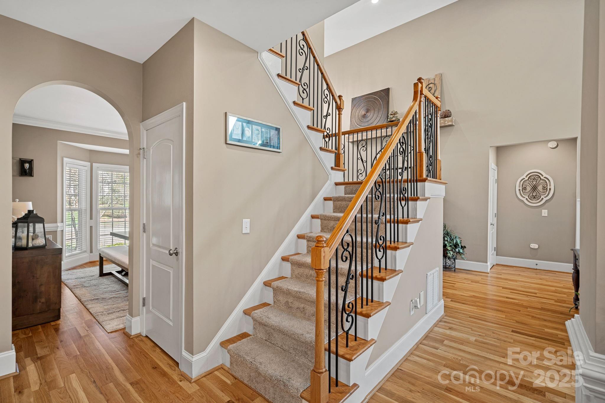 105 Elizabeth Brook Drive Davidson, NC 28036 - Photo 16 of 43 a view of a hallway with wooden floor and staircase