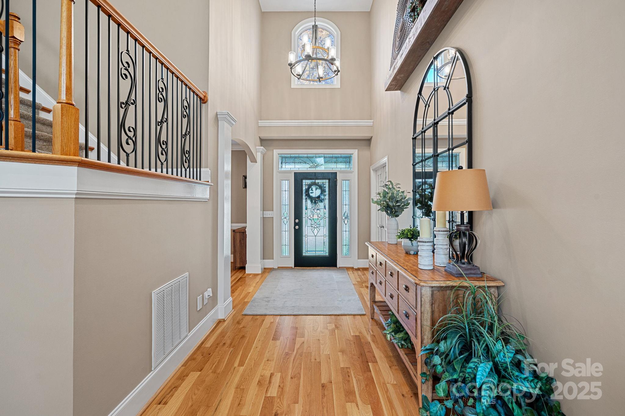 105 Elizabeth Brook Drive Davidson, NC 28036 - Photo 2 of 43 a view of a hallway with wooden floor and staircase