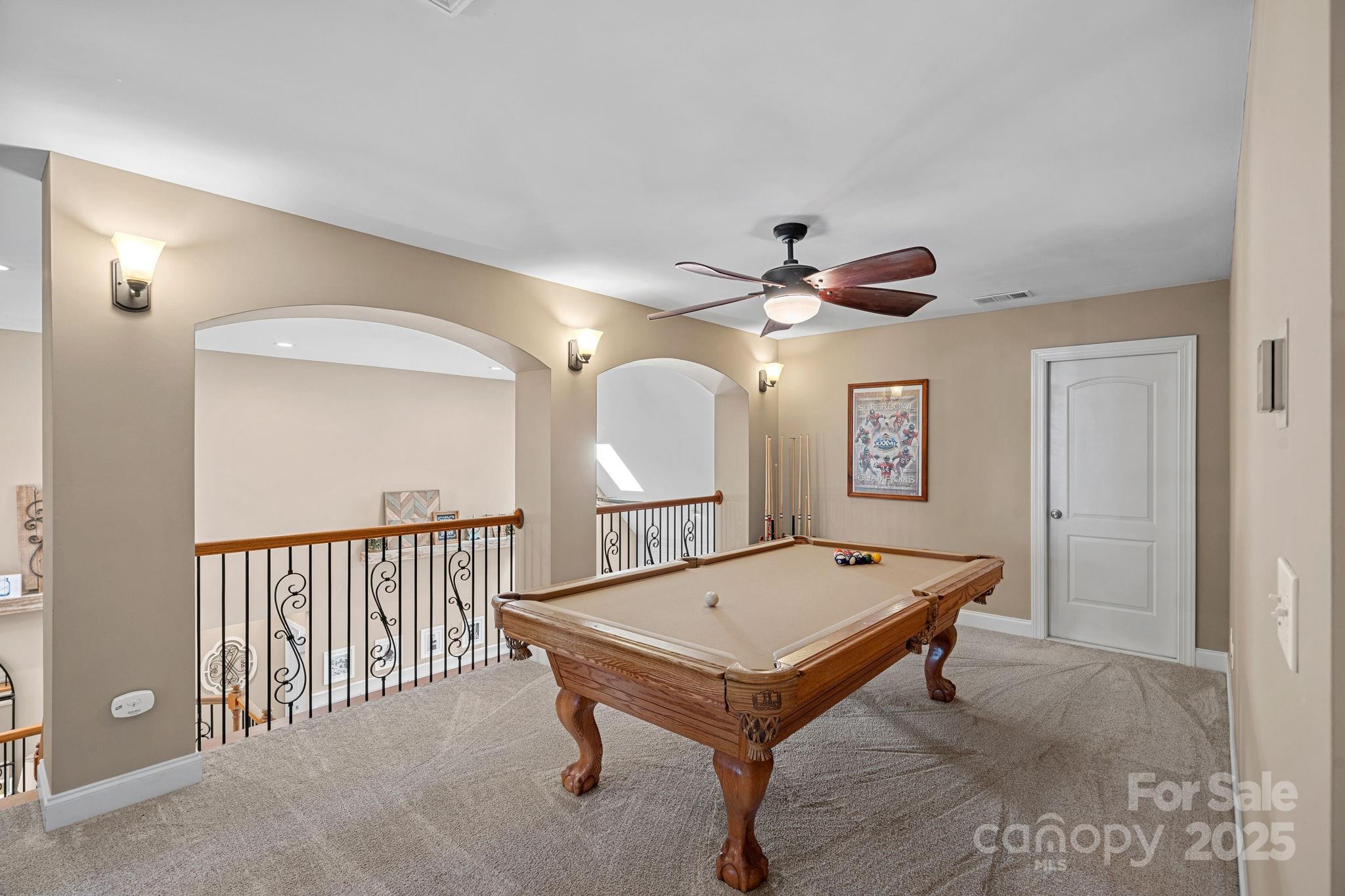 105 Elizabeth Brook Drive Davidson, NC 28036 - Photo 22 of 43 a living room with a table tennis and a chandelier