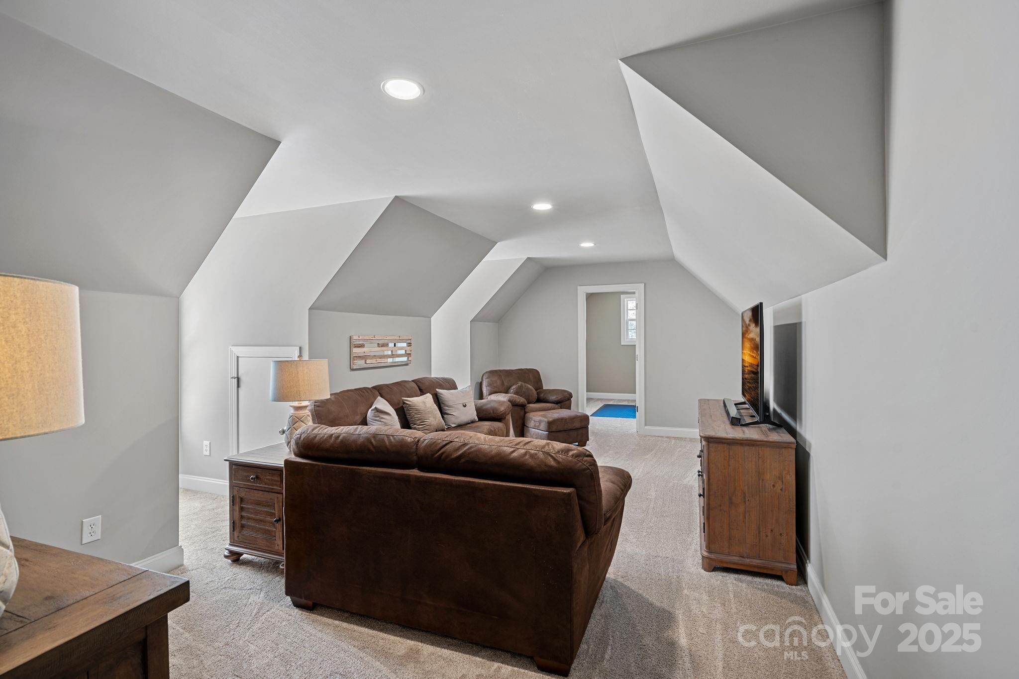 105 Elizabeth Brook Drive Davidson, NC 28036 - Photo 26 of 43 a living room with furniture and a flat screen tv