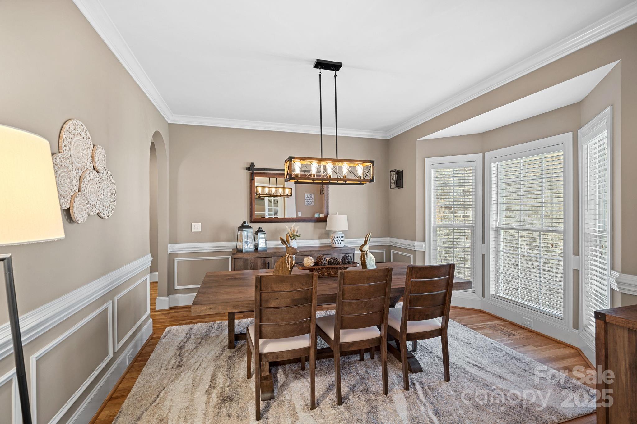 105 Elizabeth Brook Drive Davidson, NC 28036 - Photo 3 of 43 a dining room with furniture a chandelier and wooden floor