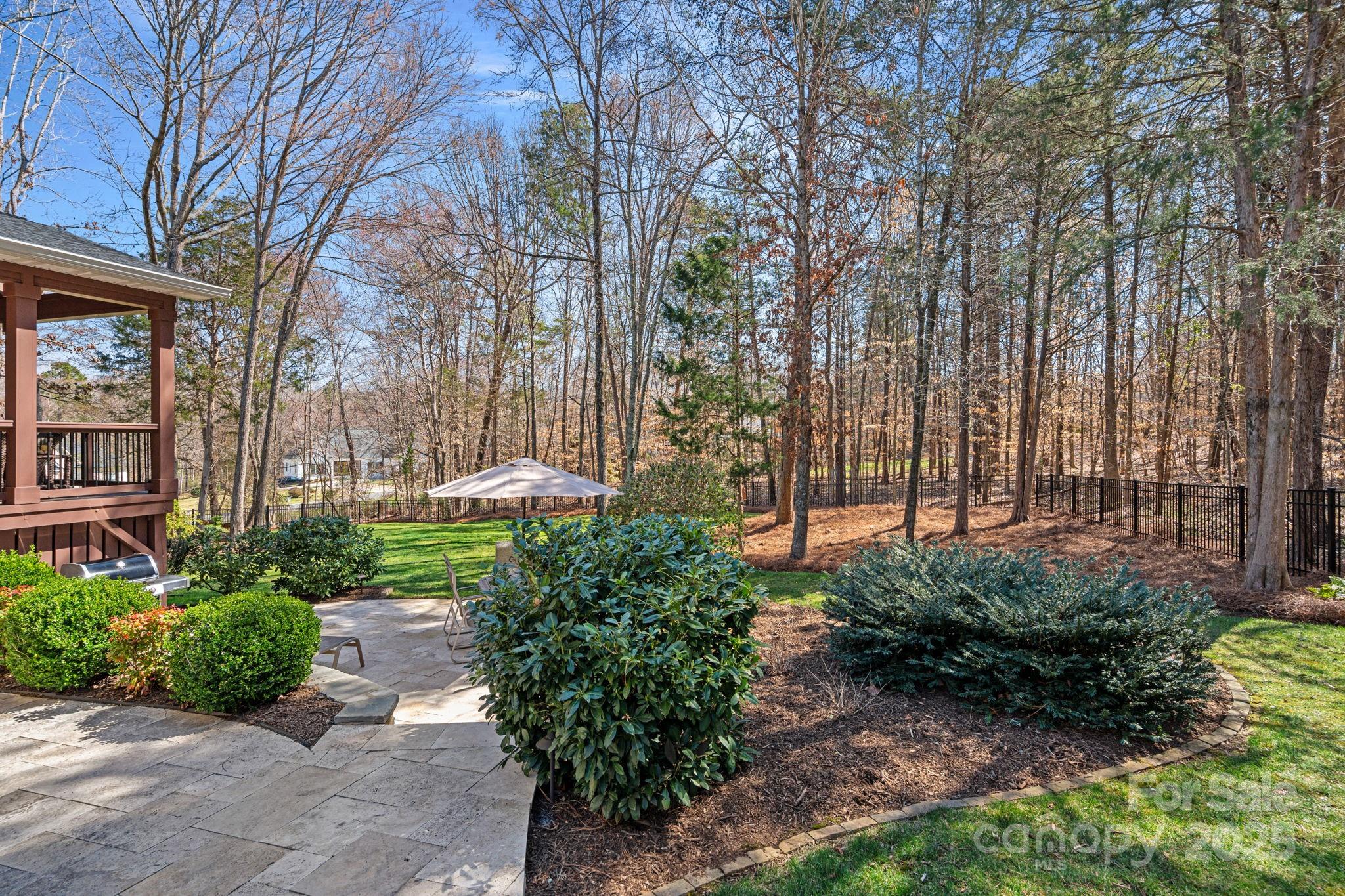 105 Elizabeth Brook Drive Davidson, NC 28036 - Photo 32 of 43 a garden with trees in front of it