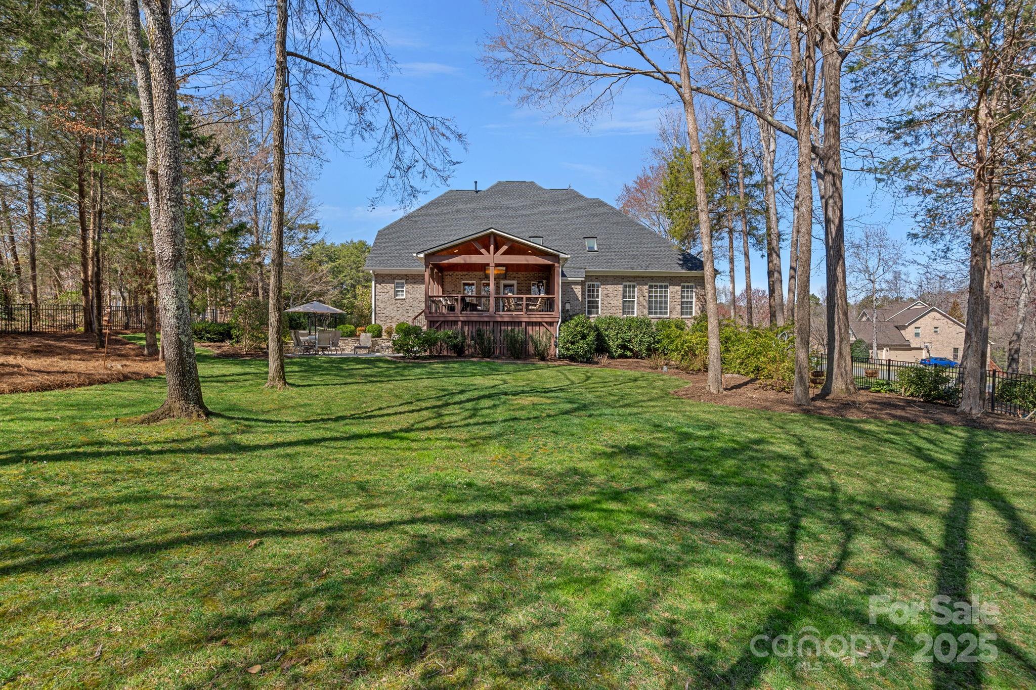 105 Elizabeth Brook Drive Davidson, NC 28036 - Photo 36 of 43 a view of a big house with a big yard and large trees