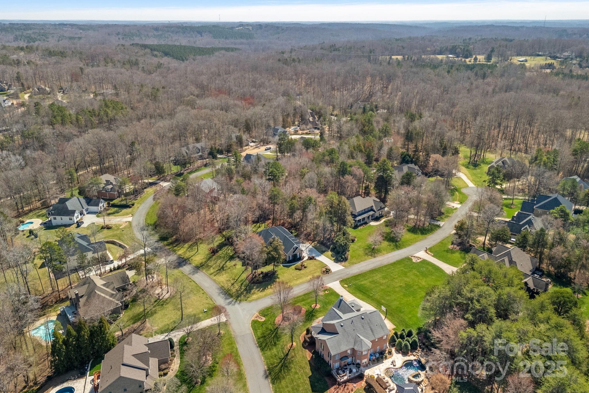 105 Elizabeth Brook Drive Davidson, NC 28036 - Photo 40 of 43 an aerial view of a houses with a lush green hillside