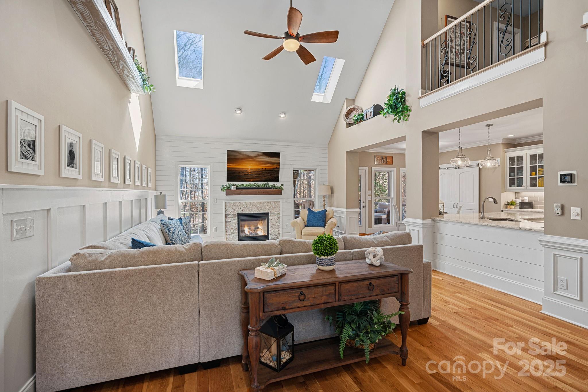 105 Elizabeth Brook Drive Davidson, NC 28036 - Photo 6 of 43 a living room with furniture a fireplace and a flat screen tv