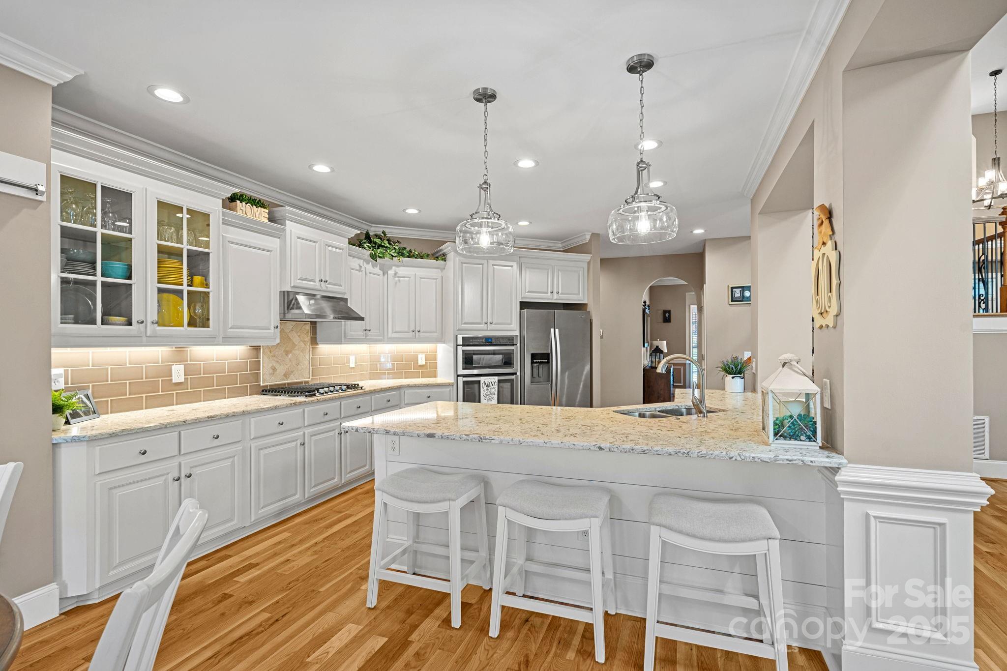 105 Elizabeth Brook Drive Davidson, NC 28036 - Photo 8 of 43 a large kitchen with kitchen island a large island in it