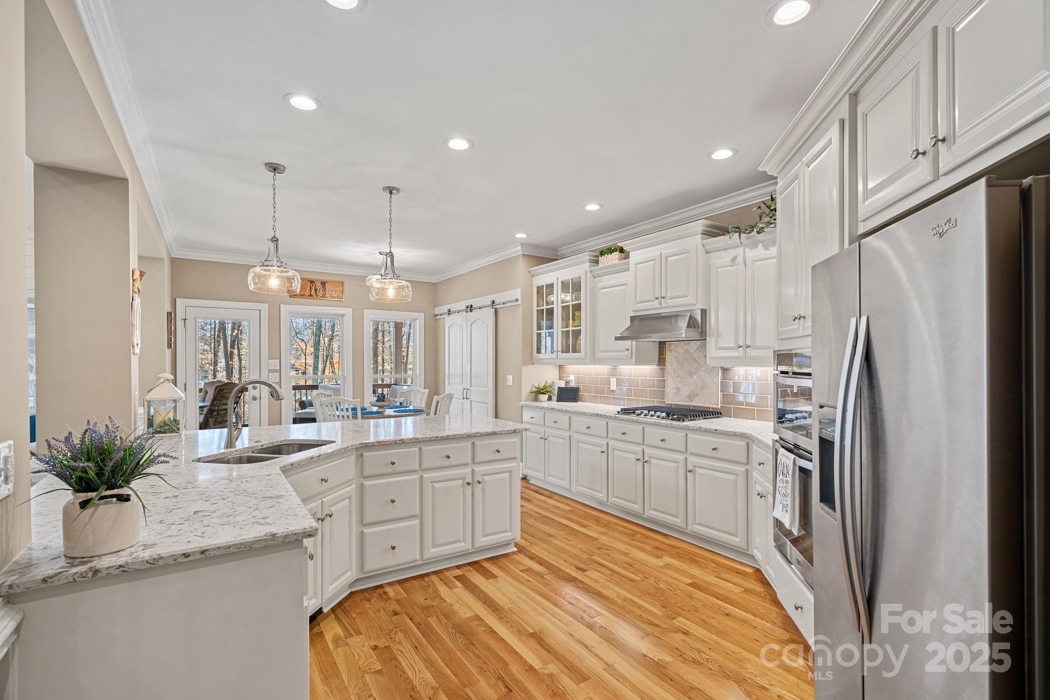 105 Elizabeth Brook Drive Davidson, NC 28036 - Photo 10 of 43 a large kitchen with kitchen island a sink stainless steel appliances and cabinets