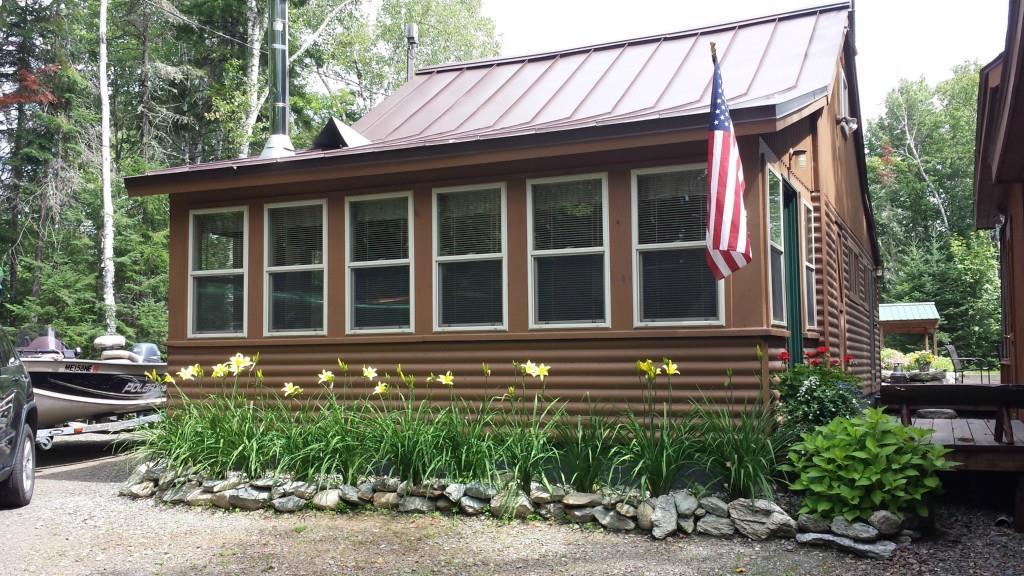 32 Bald Mt Road Oquossoc, ME 04964 - Photo 1 of 35 front of cottage