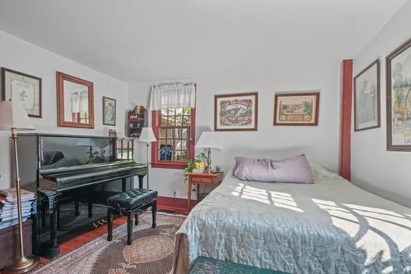 a room with furniture a window and a dresser