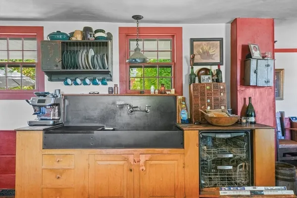 a bathroom with a sink a toilet and a window