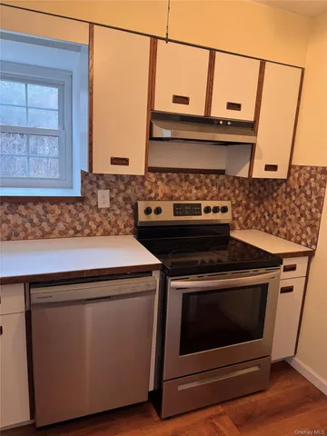 a stove top oven sitting inside of a kitchen