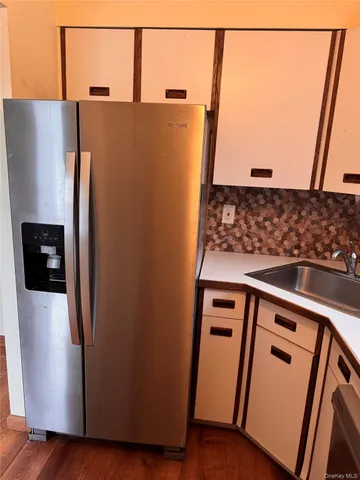 a view of a refrigerator with wooden floor