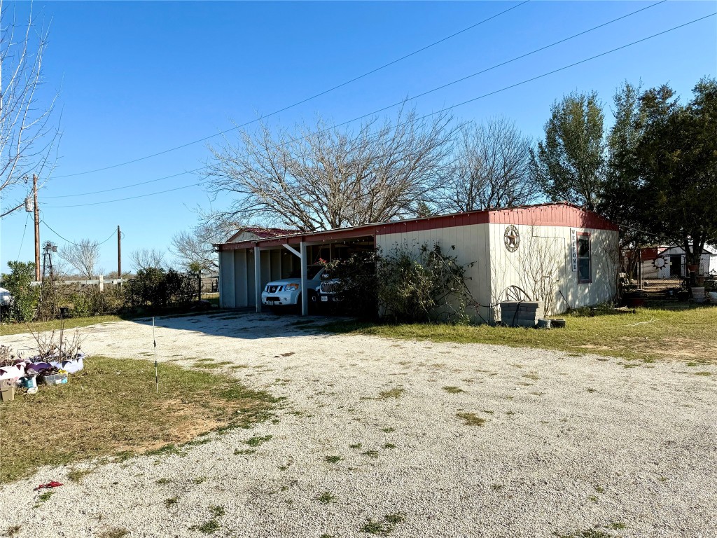685 Fox Lane Lockhart, TX 78644 - Photo 10 of 39 View of outbuilding with a carport and driveway