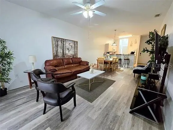 a living room with furniture and wooden floor