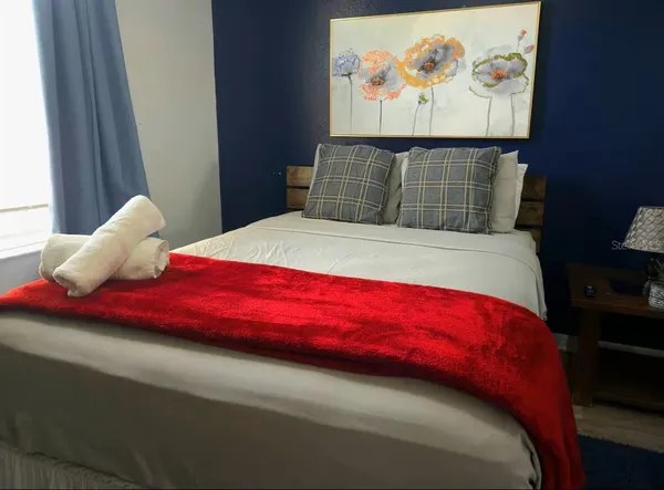 a bedroom with a bed and a window