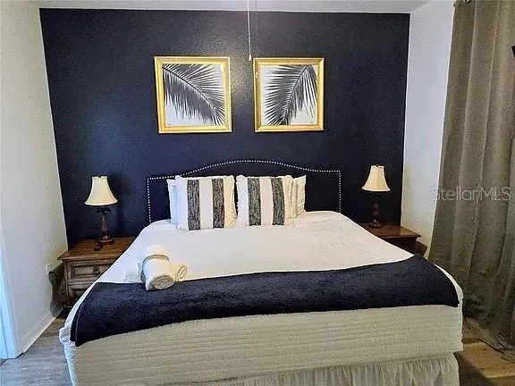 a large bed sitting in a bedroom next to a window