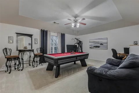 a living room with furniture a rug and a chandelier