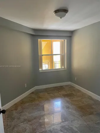 an empty room with a empty space and windows