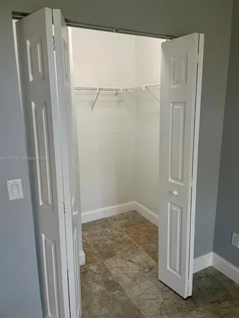 a bathroom with a granite countertop toilet a sink and a bathtub