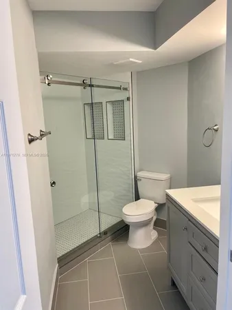 a bathroom with a toilet sink and shower