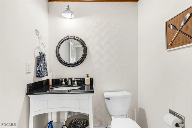 a bathroom with a toilet a sink and a mirror