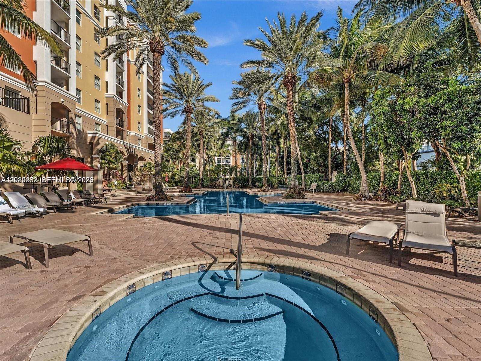17100 North Bay Road, Unit 1605 Sunny Isles Beach, FL 33160 - Photo 41 of 52 a backyard of a house with barbeque oven table and chairs