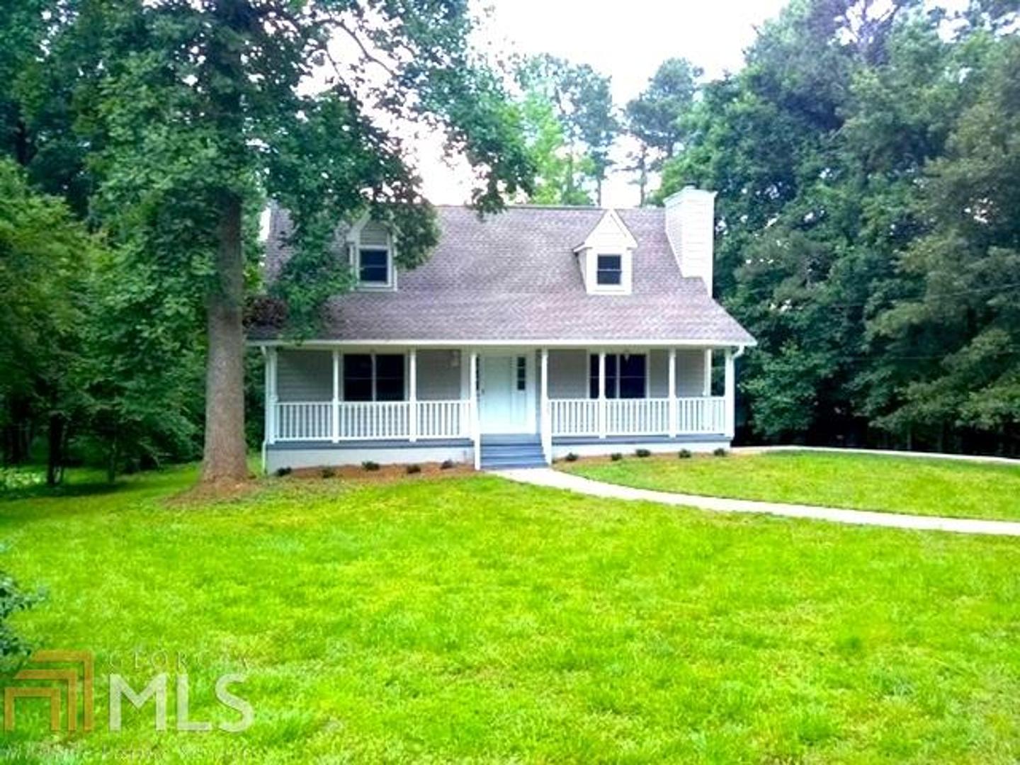 1501 Plunketts Road Buford, GA 30519 - Photo 1 of 1 a front view of a house with a yard and green space