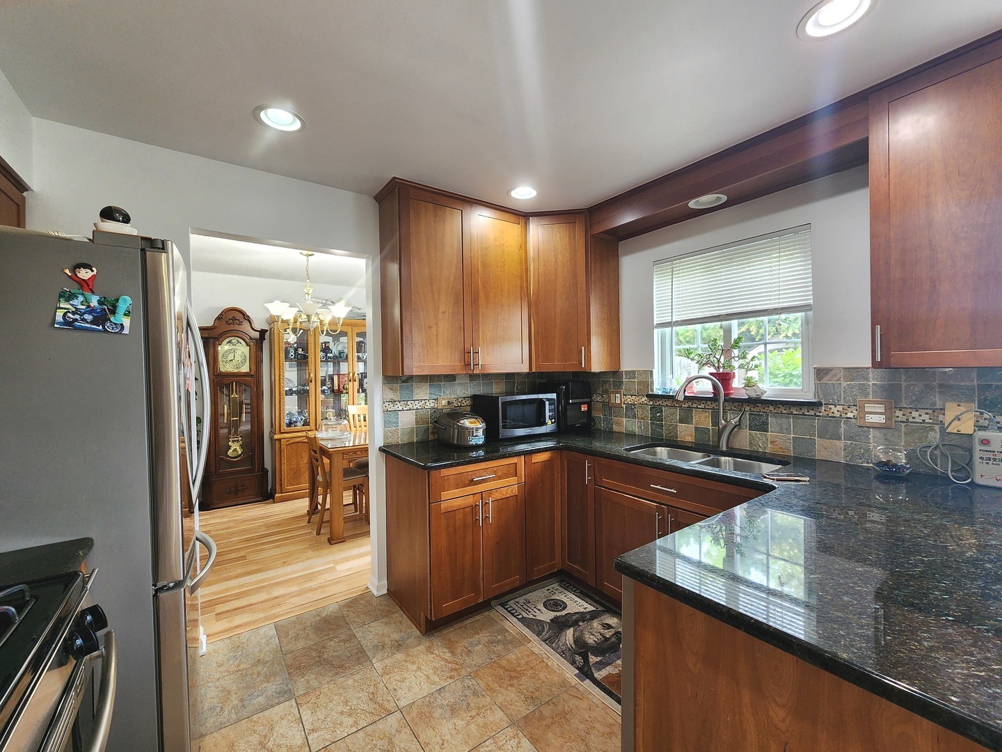 72 Wilton Lane Mundelein, IL 60060 - Photo 11 of 40 a kitchen with granite countertop a sink stove and cabinets