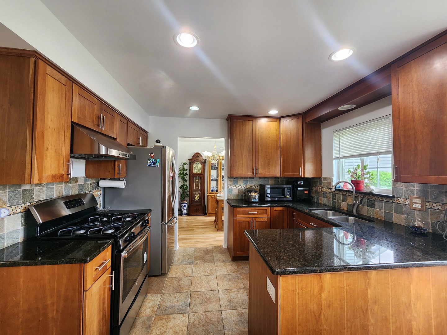 72 Wilton Lane Mundelein, IL 60060 - Photo 12 of 40 a kitchen with stainless steel appliances granite countertop a sink a stove counter space and a window