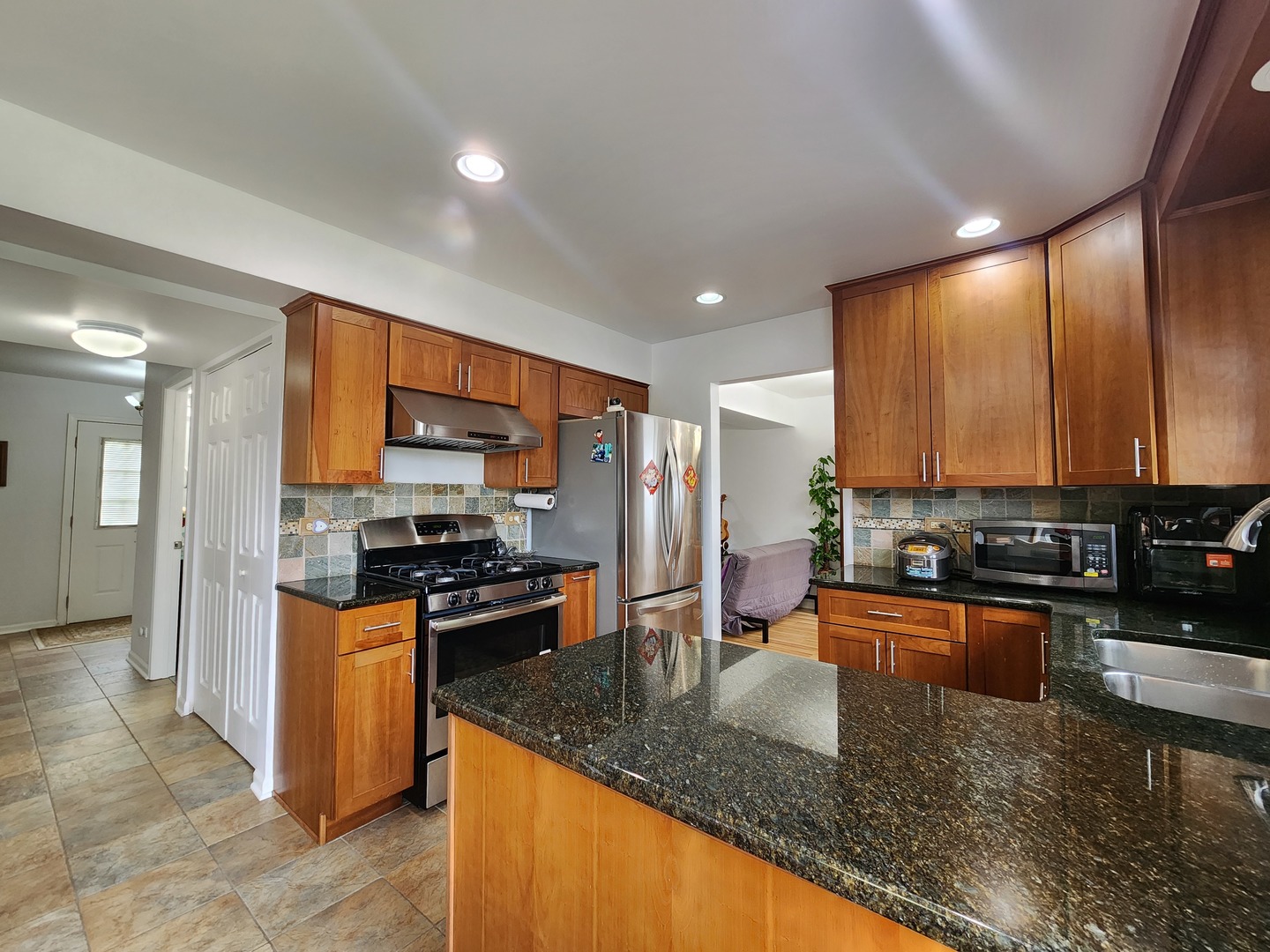 72 Wilton Lane Mundelein, IL 60060 - Photo 14 of 40 a kitchen with stainless steel appliances granite countertop a stove top oven a sink and dishwasher