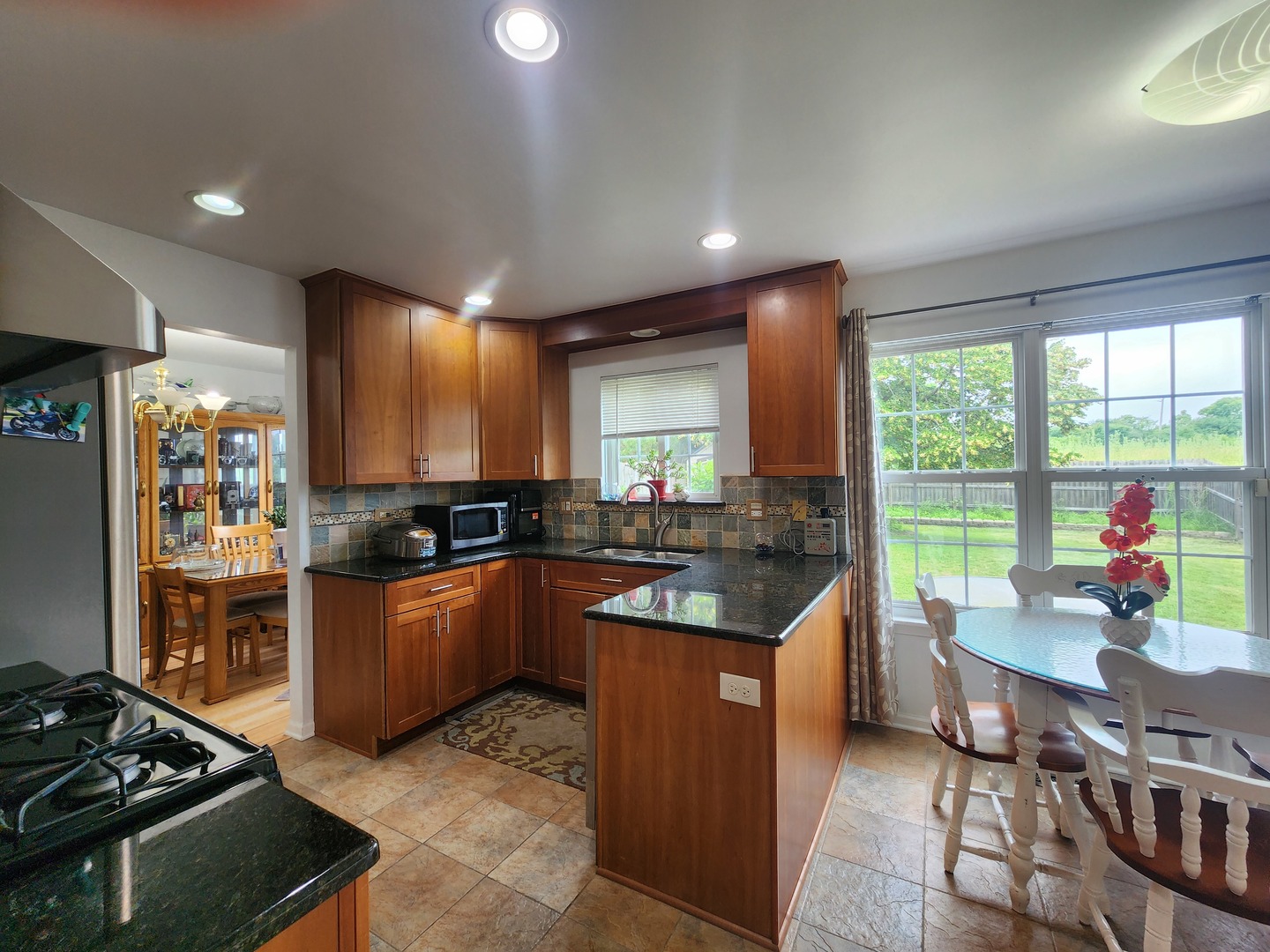 72 Wilton Lane Mundelein, IL 60060 - Photo 16 of 40 a kitchen with stainless steel appliances granite countertop a stove and a refrigerator