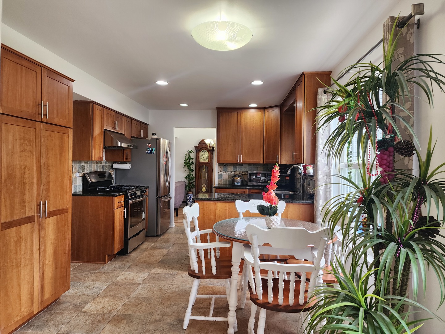 72 Wilton Lane Mundelein, IL 60060 - Photo 19 of 40 a view of a dining room with furniture a kitchen and chandelier